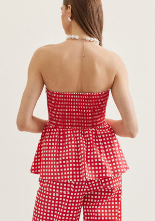 Checkered strapless peplum top featuring flared hem detail