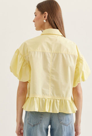 Solid short puff sleeve top featuring ruffle hem detail