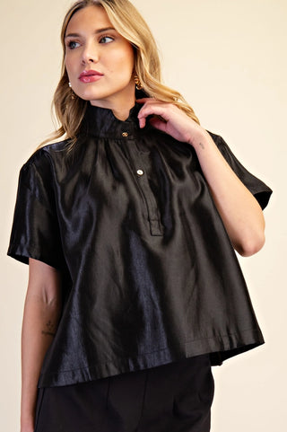 Black satin stand collar shirt with gold button placket detail and short sleeves on model.