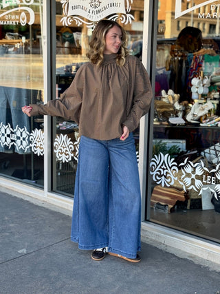 Tan and black diagonal stripe satin blouse with high mock neck and voluminous long sleeves.