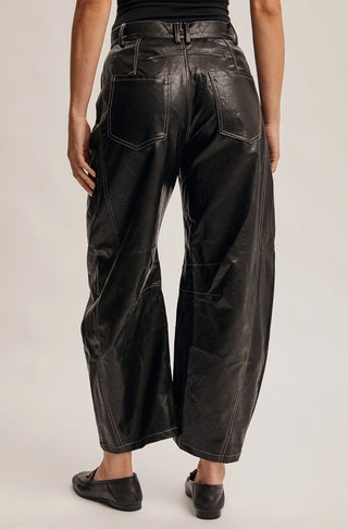 Black faux leather wide-leg pants with contrast white stitching, back pockets, and belted waist, shown from behind.
