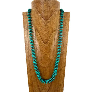 28-inch green turquoise flat disc nugget beaded necklace displayed on wooden jewelry bust form.