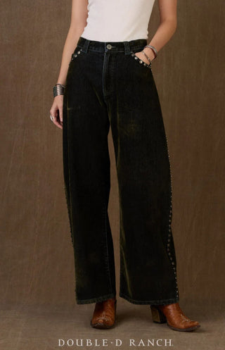 Wide-leg dark green corduroy pants with silver stud trim along sides, paired with brown cowboy boots.