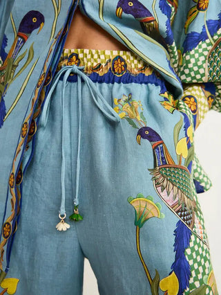 Light blue linen pants set with colorful peacock and floral print, drawstring waist with tassel detail.