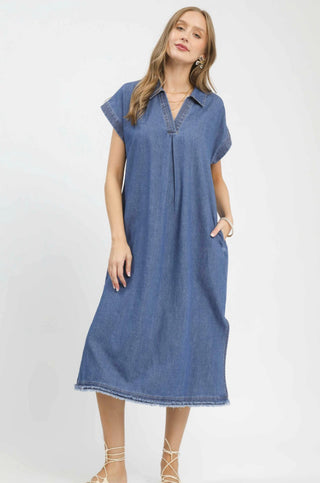 Stone washed blue denim midi dress with collar, cap sleeves, V-neckline, and frayed hem details.