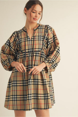 Tan plaid babydoll dress with black, red, and white check pattern, leather trim, and puffed 3/4 sleeves.