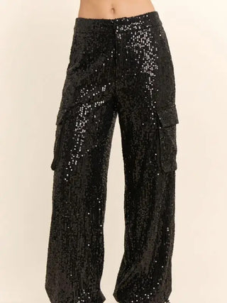 Black wide-leg sequin cargo pants with side flap pockets and relaxed silhouette on model.