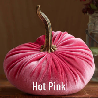 Large hot pink velvet pumpkin with natural dried stem, handcrafted fall mantel decoration with gathered fabric texture.