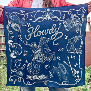 Navy blue bandana with western cowboy on horseback, "Howdy" script, rope border, guitars, revolvers, and boots illustrated in