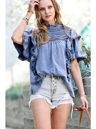 Vintage washed blue ruffle lace top with mock neck, flutter sleeves, and pintuck detailing on chest.