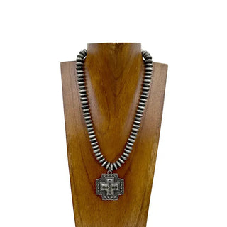 Silver Navajo pearl roundel bead necklace with engraved silver cross pendant on wooden display bust.