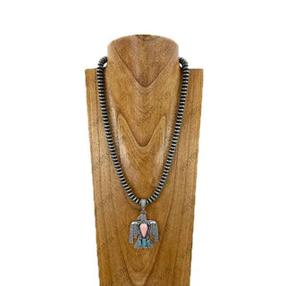 Silver Navajo pearl beaded necklace with turquoise and pink stone thunderbird eagle pendant on wood display bust.