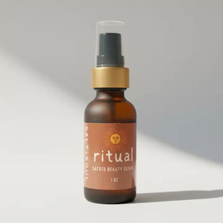 Amber glass pump bottle of Salt + Soul Ritual Sacred Beauty Elixir face oil with gold collar, warm terracotta label featuring
