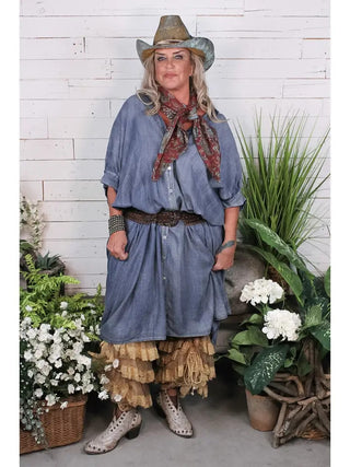 Oversized chambray blue denim Morning Meadow Dress with button front, worn with cowboy hat and lace ruffle underlayer.
