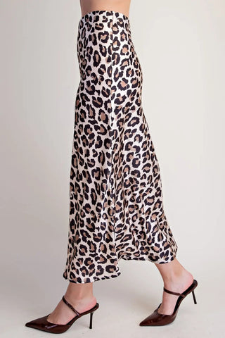 Satin leopard print high waist midi skirt in ivory, black, and tan, styled with dark brown pointed-toe heels.