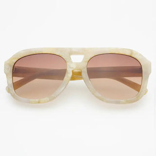 Oversized aviator sunglasses with cream marble acetate frames and gradient rose-tinted lenses, folded flat.