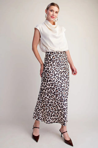 Ivory and brown leopard print satin midi skirt with high waist, styled with white cowl neck top.