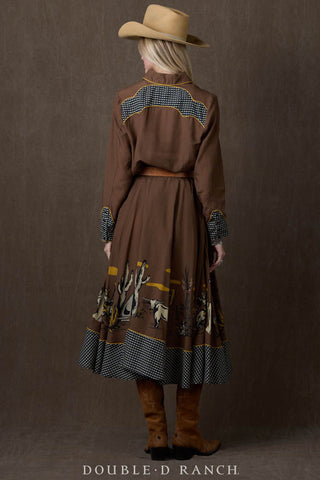 Brown western shirt with checkered yoke detail, gold piping trim, and long sleeves, worn with matching skirt.