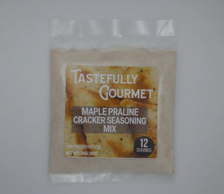 Small clear plastic packet of Tastefully Gourmet Maple Praline Cracker Seasoning Mix, 12 servings, no preservatives.