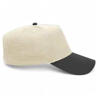 Cream and black two-tone baseball cap with structured crown, black brim, and black button top.