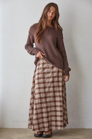 Woven cotton spandex plaid flare midi skirt in brown and beige tones, styled with brown knit sweater.