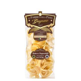 Clear bag of golden dried pappardelle pasta nests by La Fabbrica della Pasta di Gragnano, 500g, Made in Italy.