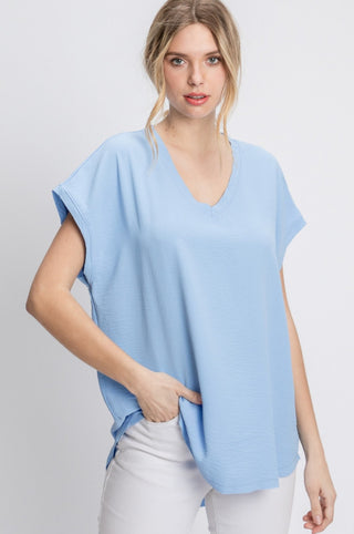 Solid top with short cap sleeves and raw edge hems