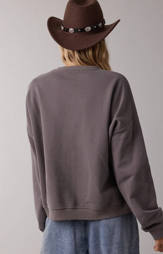 Charcoal gray French terry pullover sweatshirt, relaxed fit, paired with brown studded cowboy hat, back view.