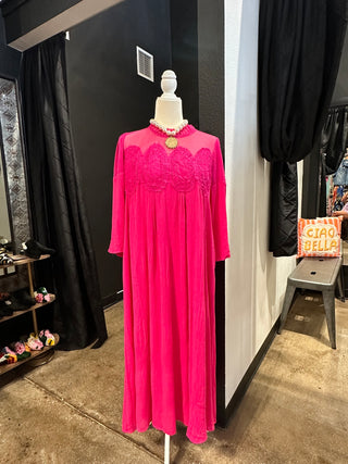 Hot pink maxi dress with sheer mesh neckline and lace embroidery detail on bust, long sleeves.