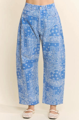 Blue and white paisley bandana print high-rise barrel leg pants with button closure and wide leg silhouette.