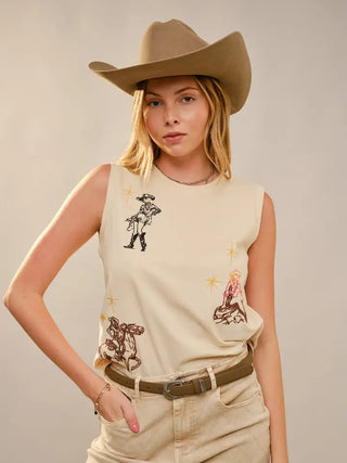 Cream sleeveless top with western cowgirl embroidered motifs, worn with tan cowboy hat and olive belt.