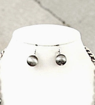 Navajo pearl bead drop earrings in oxidized sterling silver displayed on white jewelry bust.