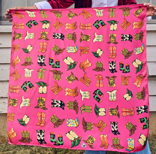 Hot pink silk bandana featuring colorful cowboy boot pairs in green, black, brown, and cream patterns.
