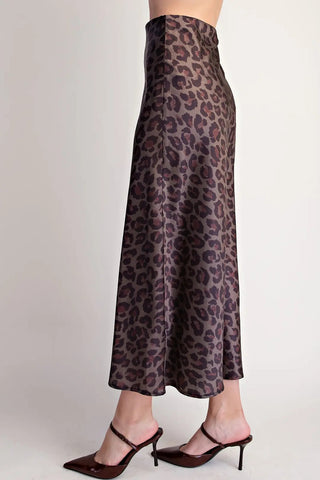 Dark brown leopard print satin high waist midi skirt with flowy silhouette, styled with burgundy heels.