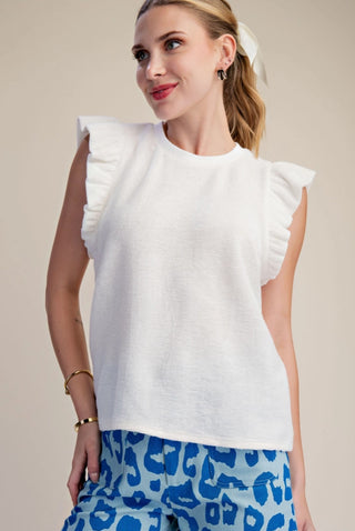 White ruffle sleeve knit top in soft brush fabric, styled with blue leopard print shorts.