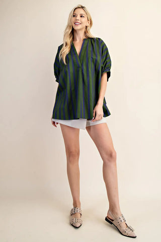 Oversized v-neck placket top in olive green and navy blue vertical stripes with short puffed sleeves.