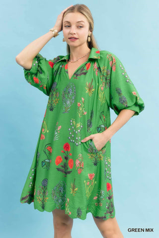 Green floral encyclopedia print mini dress with puff sleeves, collar neckline, and side pockets.