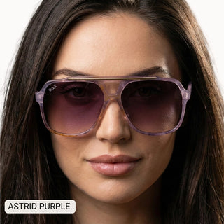 Woman wearing DAX Astrid oversized aviator sunglasses in translucent purple frames with gradient purple lenses.