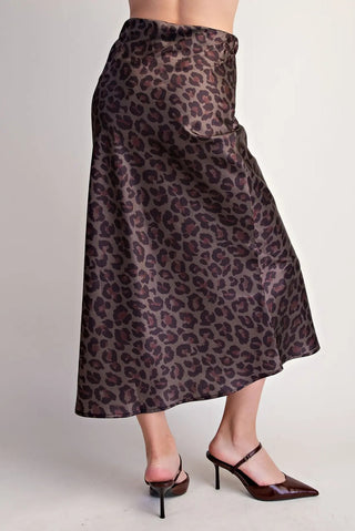 Brown leopard print satin midi skirt with high waist, A-line silhouette, styled with dark brown heels.