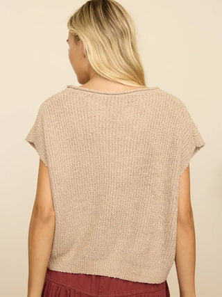 Beige knit sweater top with split neck, short cap sleeves, and ribbed hem, back view.