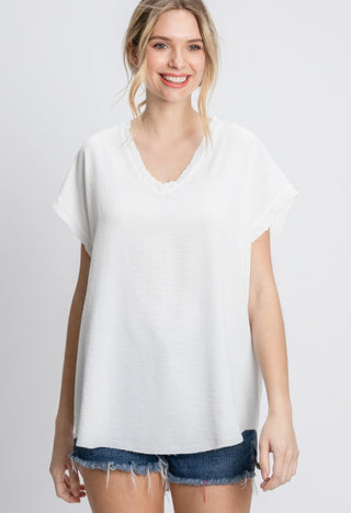 Solid top with short cap sleeves and raw edge hems