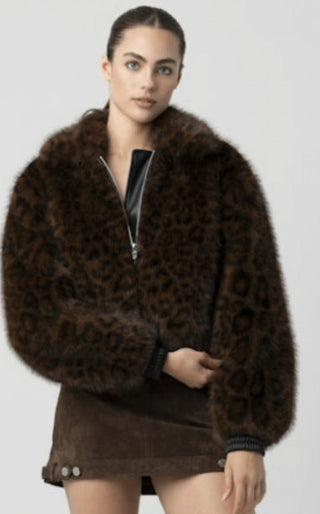 Brown leopard print faux fur zip-up bomber jacket with ribbed cuffs, worn over mini skirt.