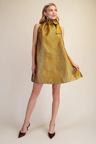 Gold metallic textured jacquard mini dress with ruffle tie neck and sleeveless A-line silhouette.
