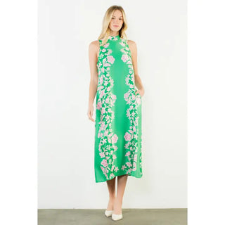 Bright green sleeveless midi dress with pink and white floral border print, worn by blonde model.