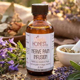 Amber glass bottle of Simply Honest Co. Nerve Pain Infusion surrounded by fresh lavender, sage, and dried herbs.