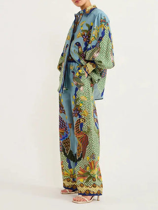 Vibrant peacock print matching set featuring blue top and wide-leg pants with colorful botanical and bird motifs.
