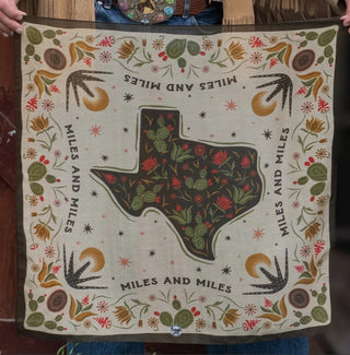 Tan bandana featuring Texas state outline filled with red florals and cacti, bordered by southwestern botanical designs.