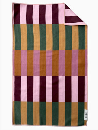 Multicolored striped waffle-knit hand towel featuring pink, burgundy, green, and golden yellow blocks.