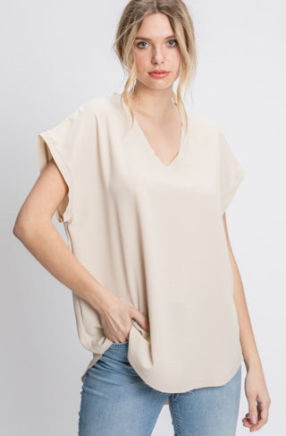 Solid top with short cap sleeves and raw edge hems