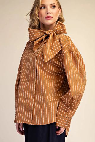 Camel brown pinstripe oversized shirt with large bow tie neck detail and long sleeves.